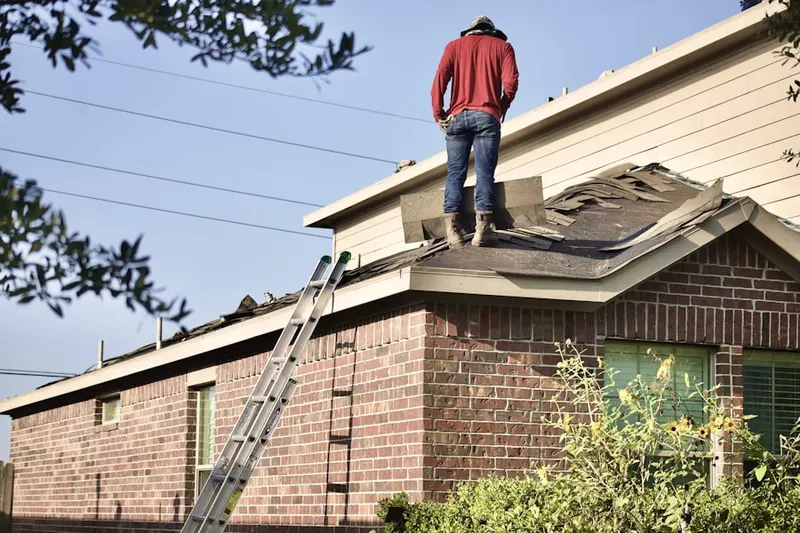 Professional roofer working on a residential roof in Fountain Mills